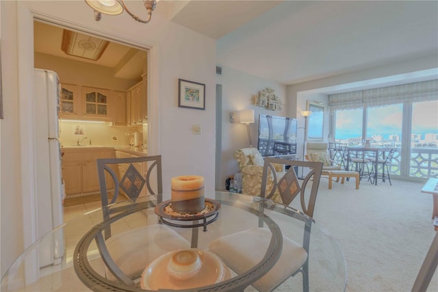 dining area with light carpet and sink