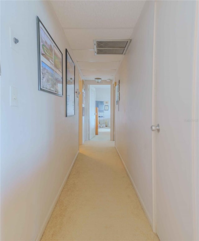 hallway with light colored carpet