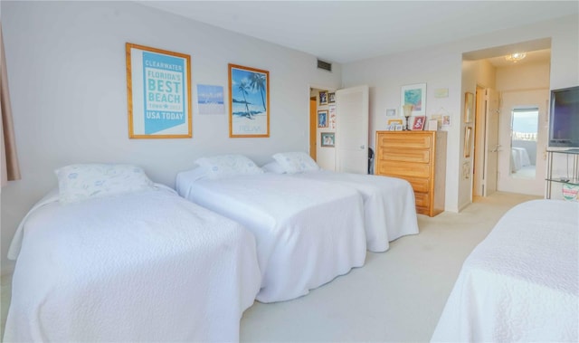 carpeted bedroom featuring ensuite bath