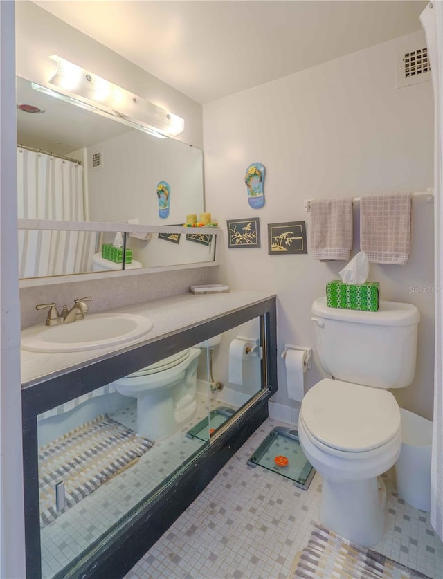 bathroom featuring tile patterned flooring, vanity, toilet, and a shower with shower curtain