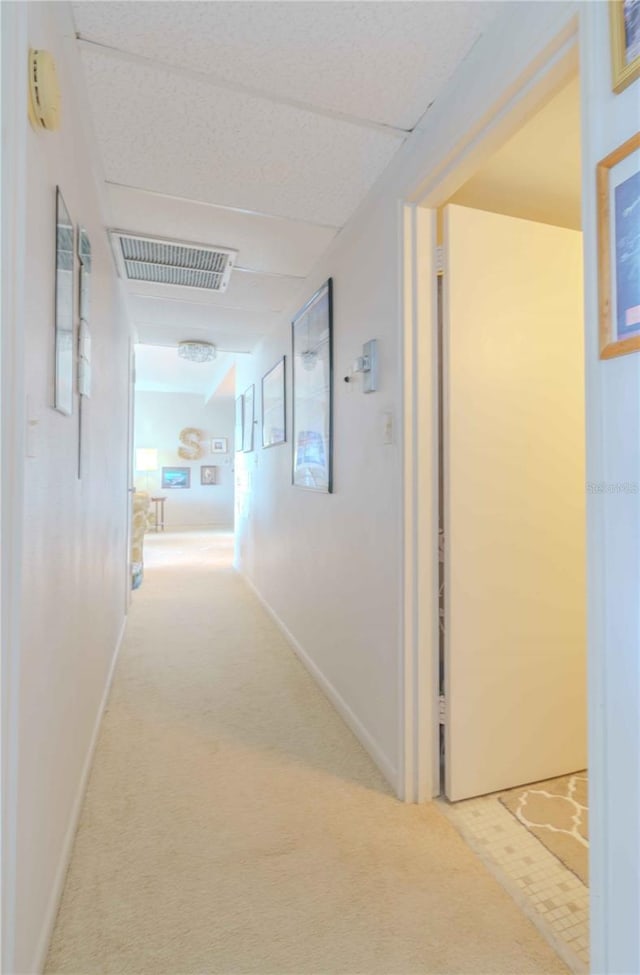 hallway with light colored carpet