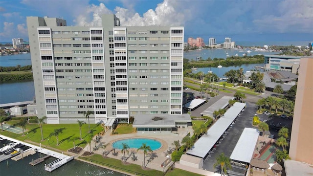 view of property featuring a water view and a community pool