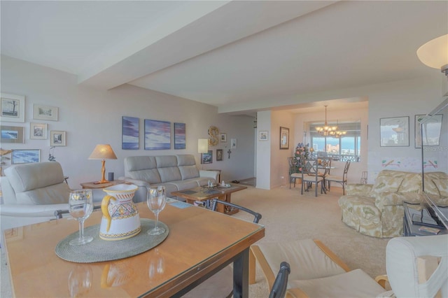 living area with a notable chandelier, carpet flooring, and beamed ceiling