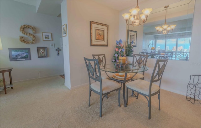 carpeted dining space with baseboards and an inviting chandelier