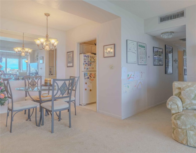 dining area featuring light carpet, baseboards, visible vents, and a notable chandelier