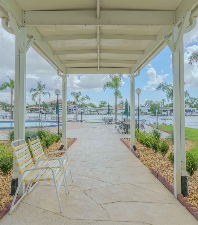 exterior space featuring outdoor dining space and a community pool