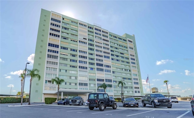 view of building exterior with uncovered parking