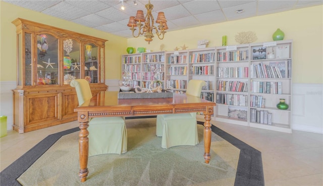 office space with a chandelier and wainscoting