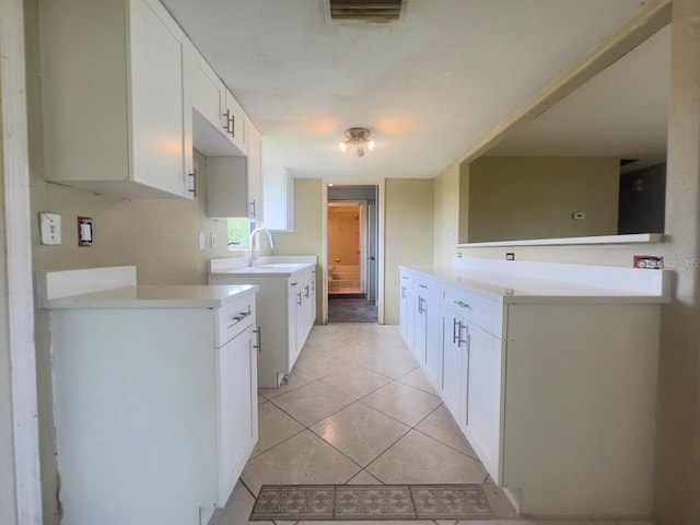 kitchen with white cabinetry and light tile patterned flooring