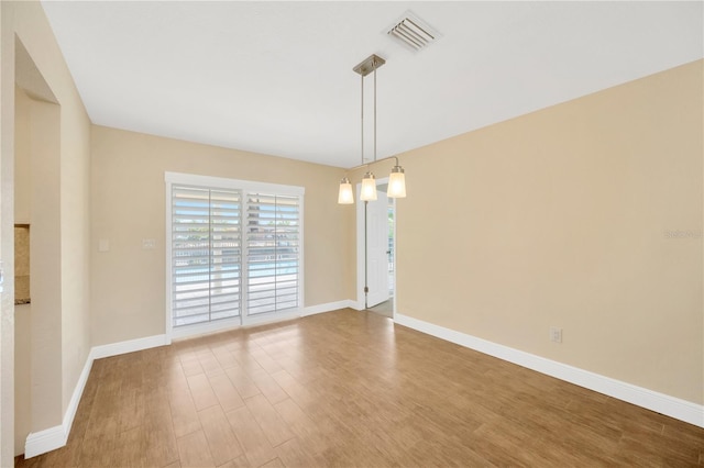 spare room with hardwood / wood-style flooring