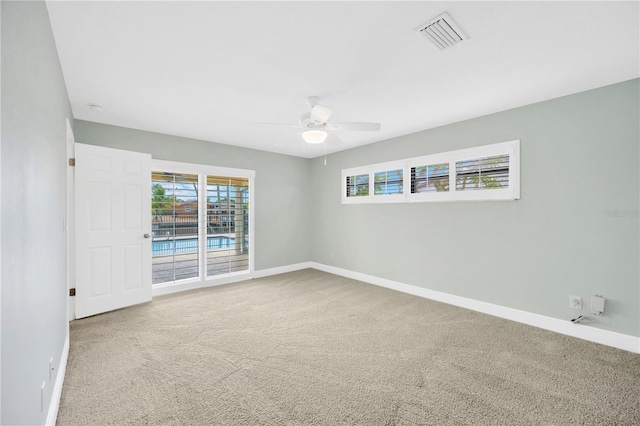 unfurnished room with carpet flooring and ceiling fan