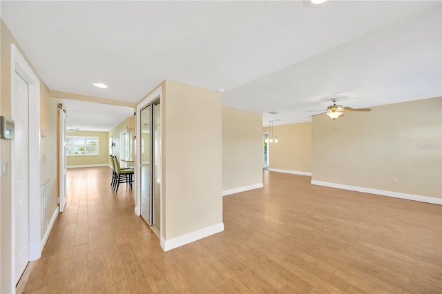 corridor with light hardwood / wood-style flooring