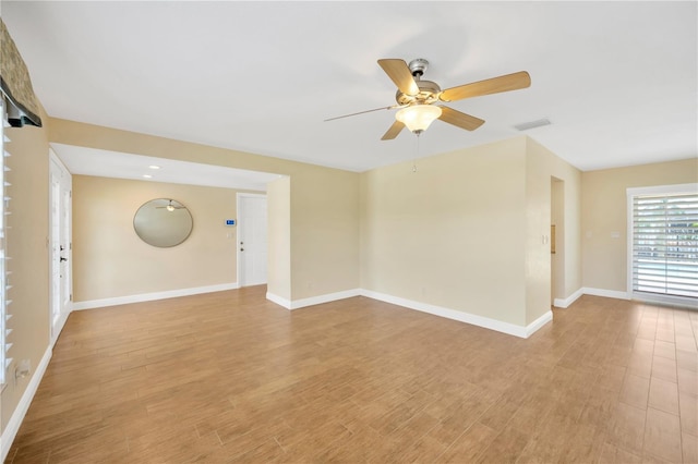 empty room with ceiling fan and light wood-type flooring