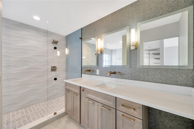 bathroom featuring decorative backsplash, tile patterned floors, a tile shower, vanity, and tile walls