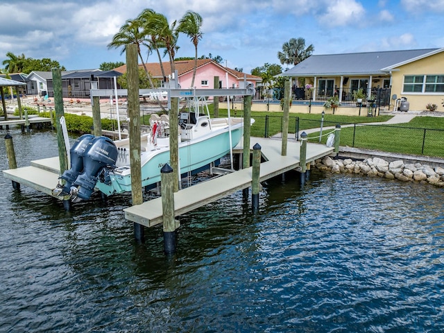 dock area with a water view and a yard