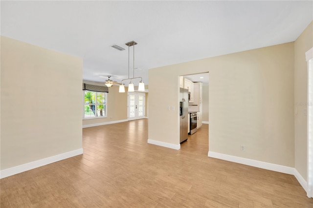 unfurnished room featuring light wood-type flooring and ceiling fan