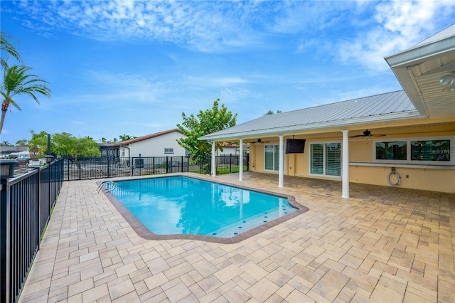 view of pool with ceiling fan and a patio