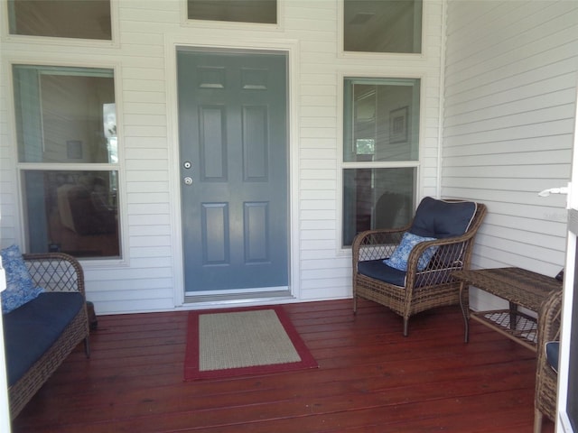 view of exterior entry featuring a wooden deck