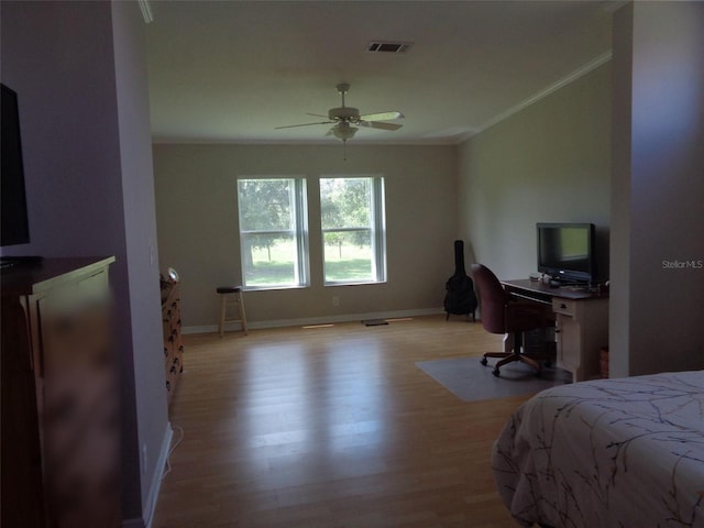 bedroom with ornamental molding, light wood-type flooring, and ceiling fan