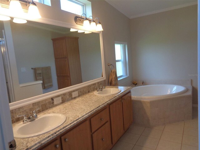 bathroom featuring tile patterned floors, a relaxing tiled tub, ornamental molding, and vanity