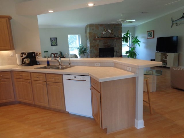 kitchen with dishwasher, a breakfast bar, kitchen peninsula, sink, and ceiling fan