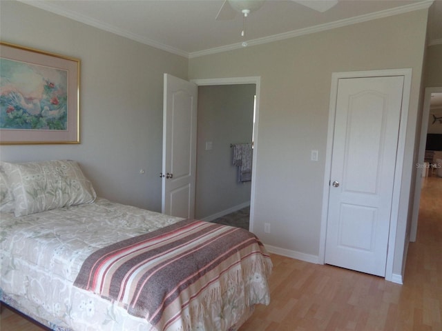 bedroom featuring ceiling fan, ornamental molding, and hardwood / wood-style flooring