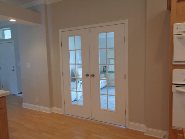 doorway to outside with light hardwood / wood-style floors and french doors