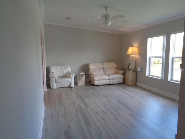 unfurnished living room with crown molding, ceiling fan, and light wood-type flooring