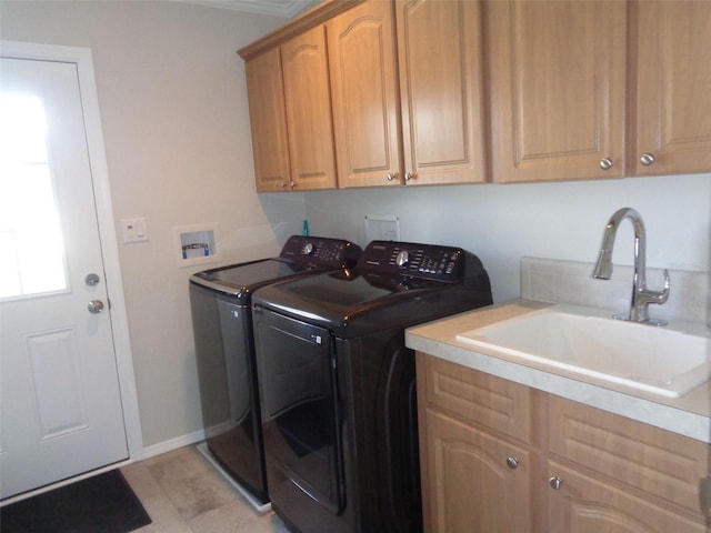 laundry room with cabinets, washing machine and clothes dryer, and sink