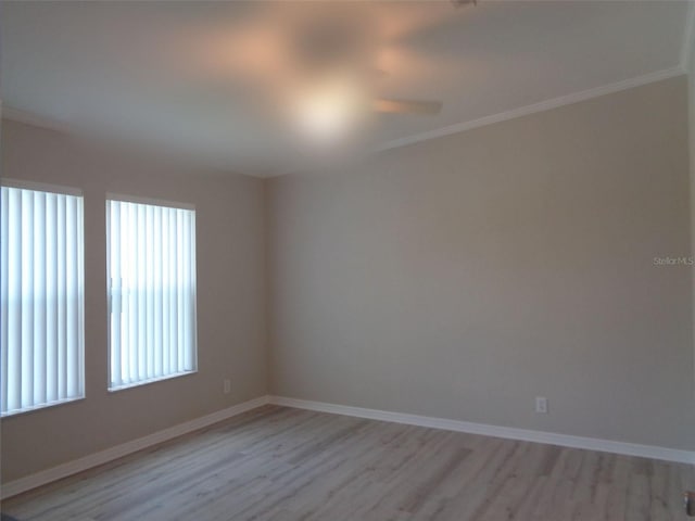 spare room with ornamental molding and hardwood / wood-style flooring