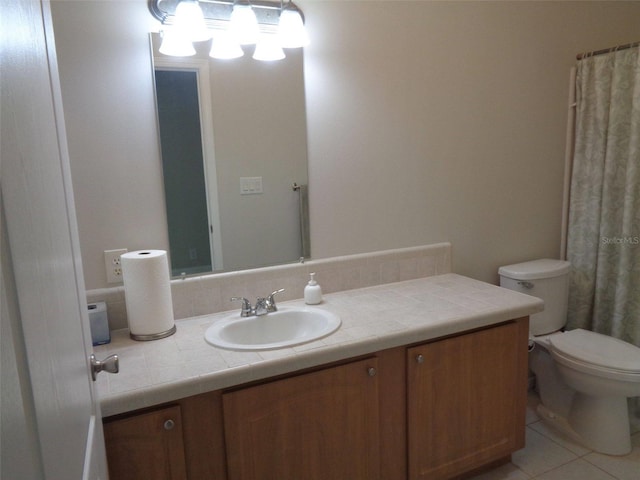 bathroom with tile patterned floors, toilet, and vanity