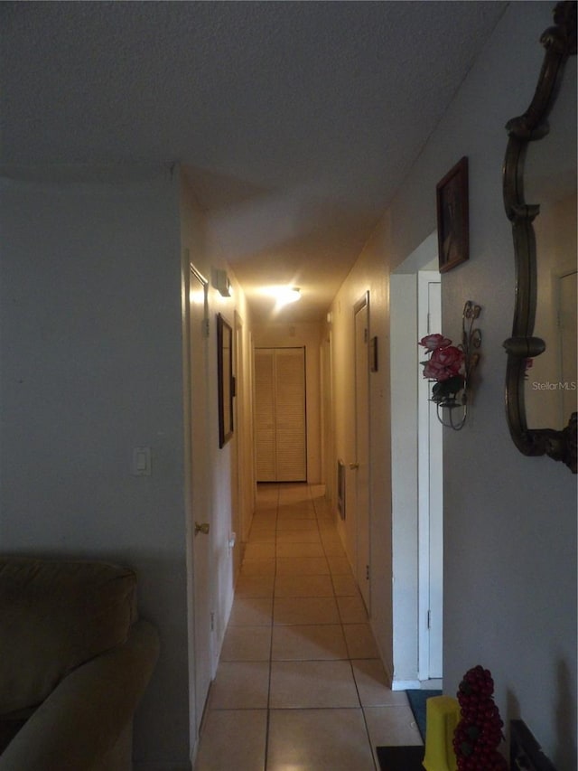 hall with light tile patterned flooring