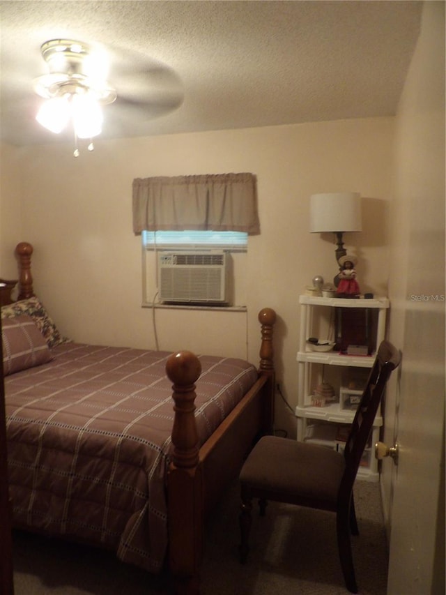 bedroom with cooling unit and a textured ceiling