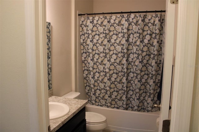 full bathroom with vanity, shower / tub combo, and toilet