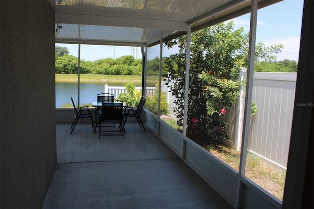 sunroom with a healthy amount of sunlight and a water view