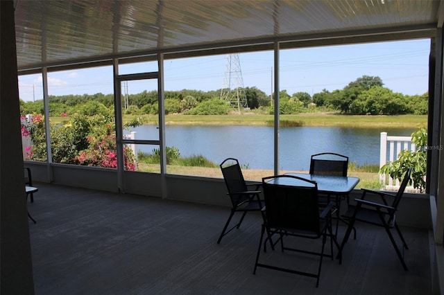 sunroom with plenty of natural light and a water view