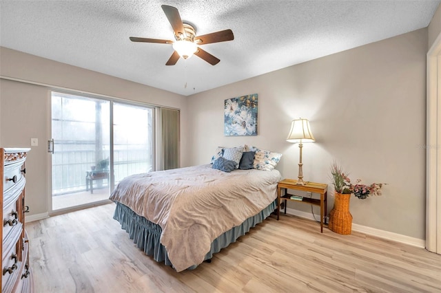 bedroom featuring light hardwood / wood-style flooring, ceiling fan, access to outside, and a textured ceiling