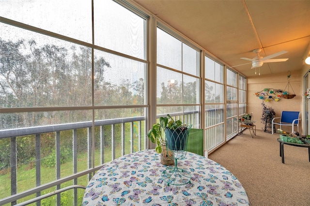 sunroom / solarium featuring ceiling fan