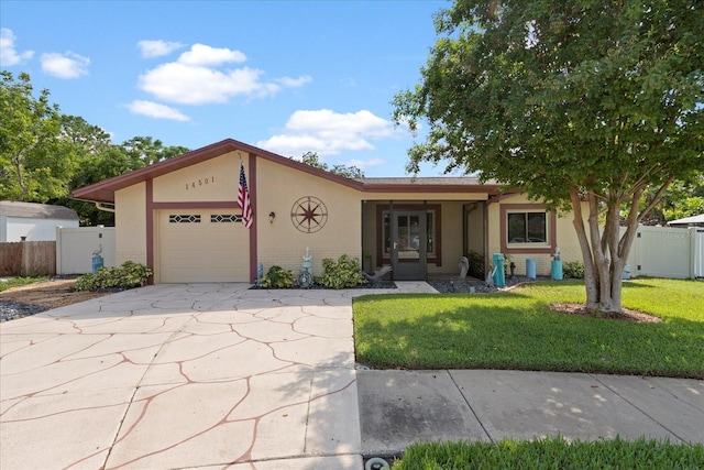 view of front of property with a garage and a front yard