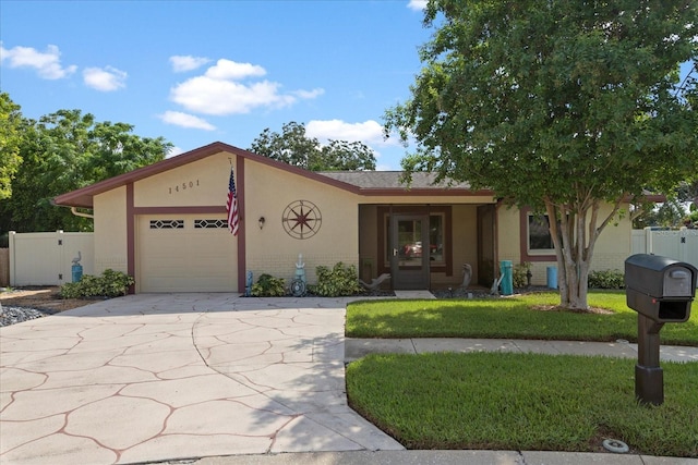 view of front of home with french doors, a garage, and a front yard