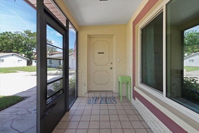 exterior space featuring a textured ceiling and light tile patterned flooring