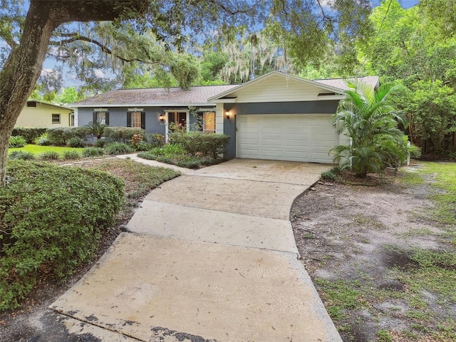 ranch-style house with an attached garage and driveway