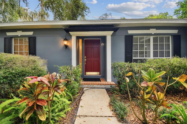 doorway to property with stucco siding