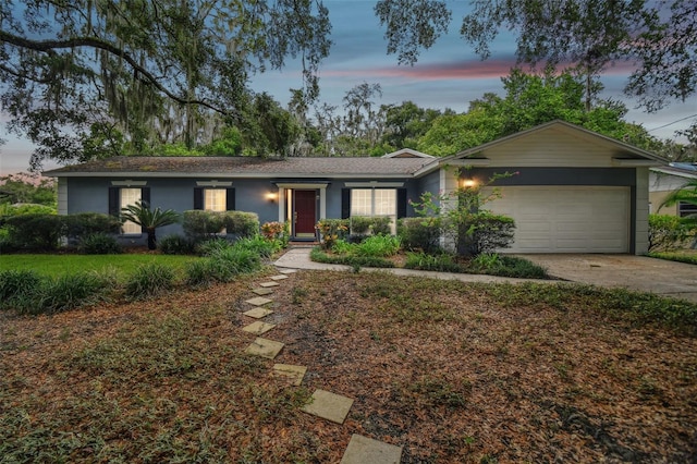 ranch-style home featuring a garage and driveway