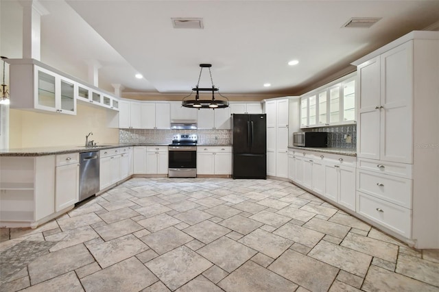 kitchen featuring pendant lighting, stainless steel appliances, tasteful backsplash, white cabinets, and under cabinet range hood