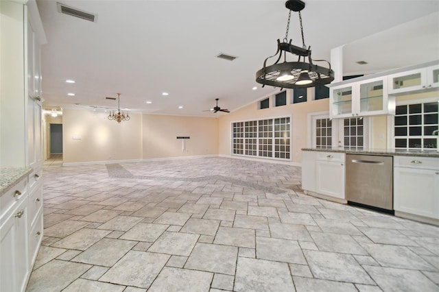 kitchen with light stone counters, stainless steel dishwasher, visible vents, and white cabinets