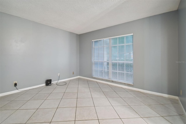 unfurnished room featuring baseboards and a textured ceiling