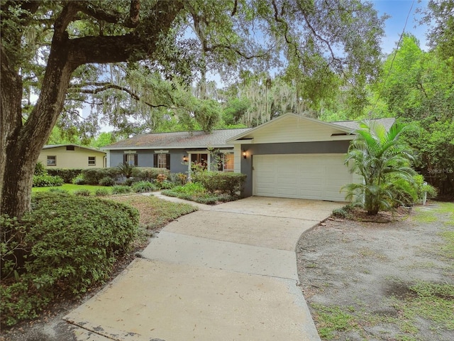 ranch-style house with a garage and concrete driveway