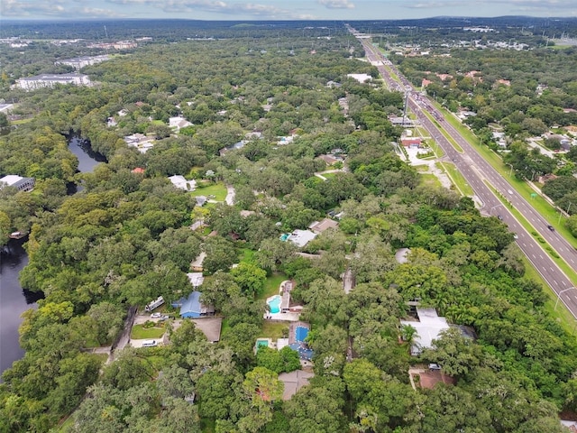 birds eye view of property with a view of trees