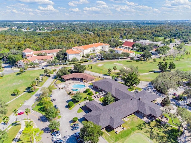 bird's eye view featuring golf course view and a wooded view